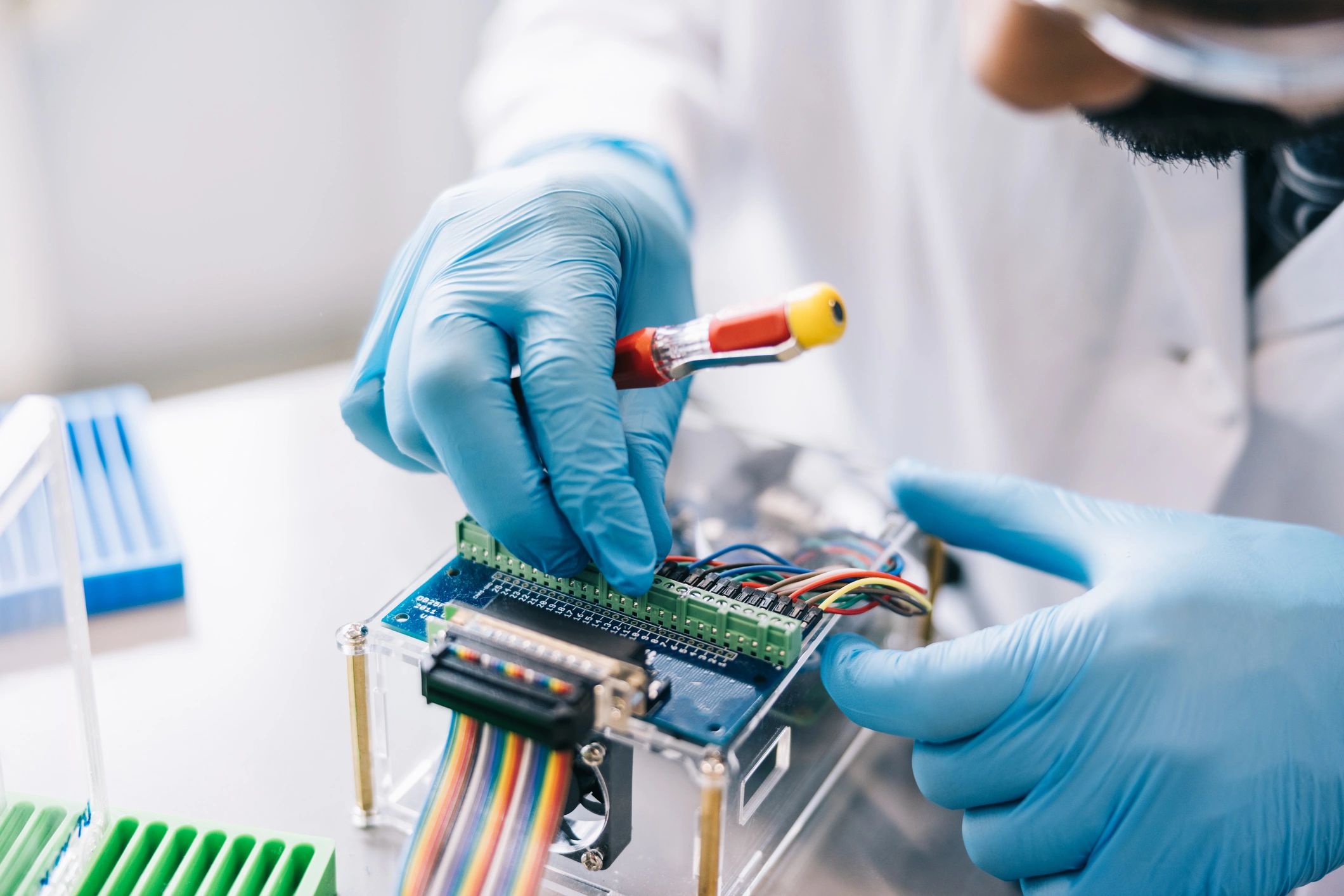 Biomedical technician servicing medical equipment in a clinical environment