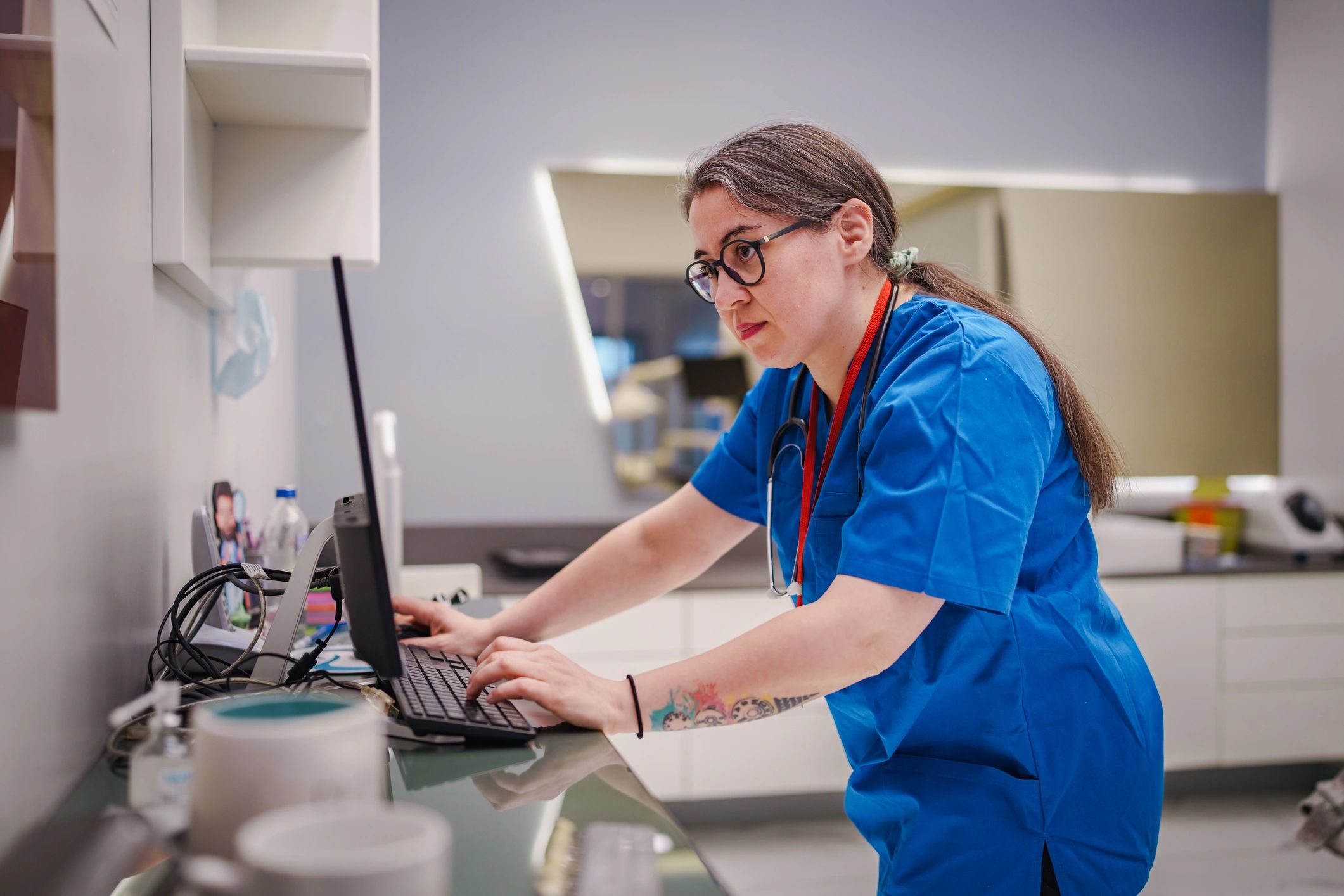 Healthcare professional coordinating service activity at a workstation