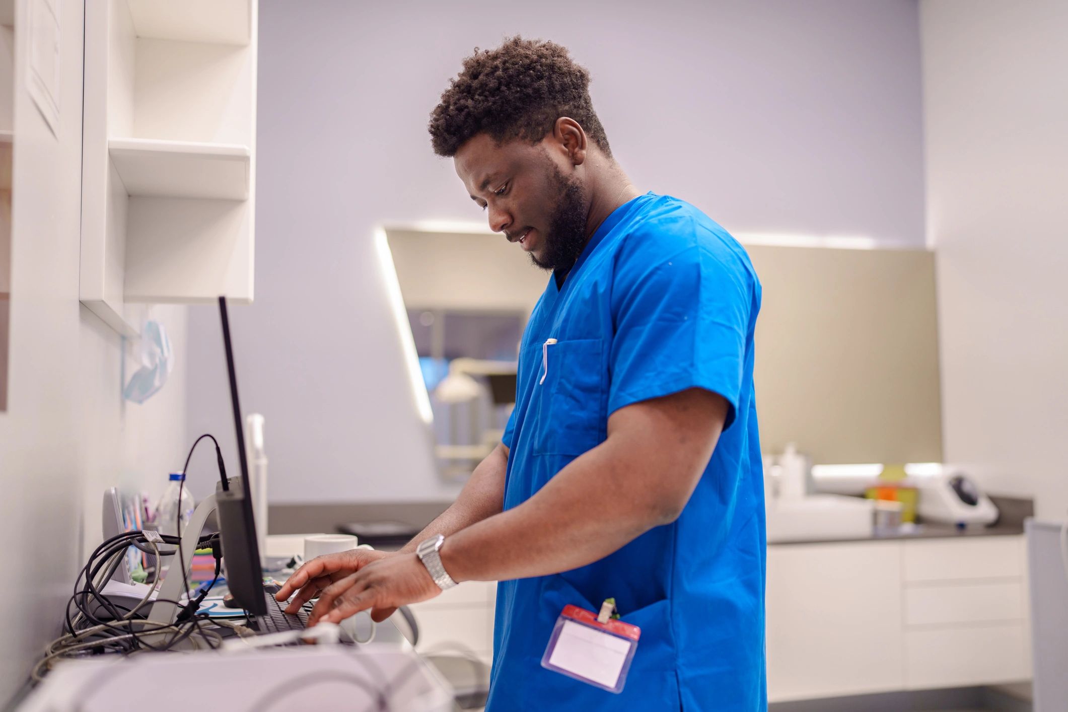 Healthcare professional using a computer in a clinical environment